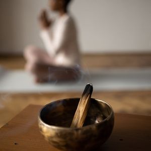 A small bowl of incense in a yoga room.