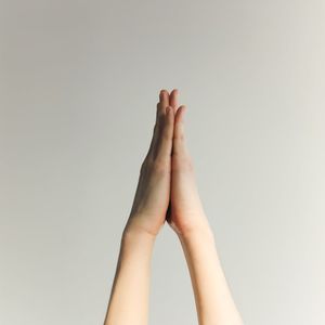 Focus on hands in a prayer position.