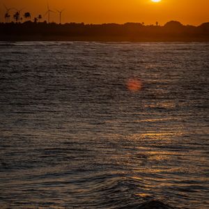 Silhouette of a person doing a tree pose.